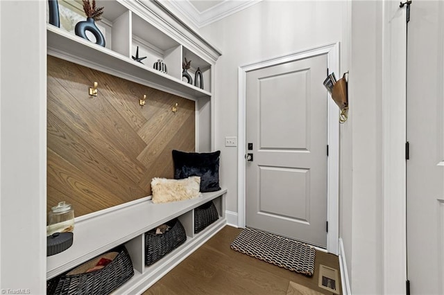 mudroom featuring visible vents, crown molding, and wood finished floors