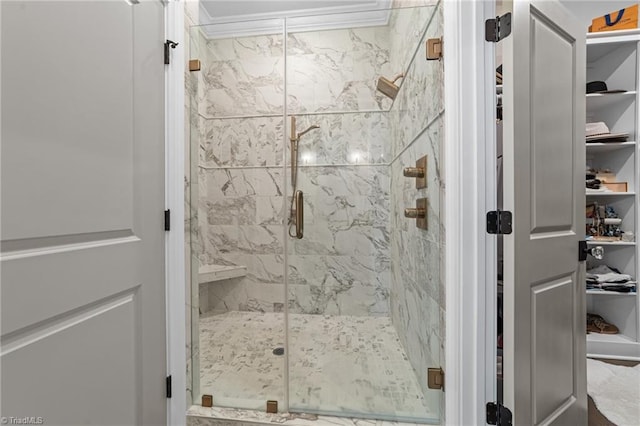 full bathroom featuring a marble finish shower and crown molding