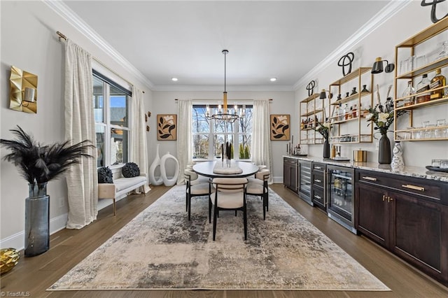 dining space with beverage cooler, ornamental molding, dark wood-style floors, and baseboards