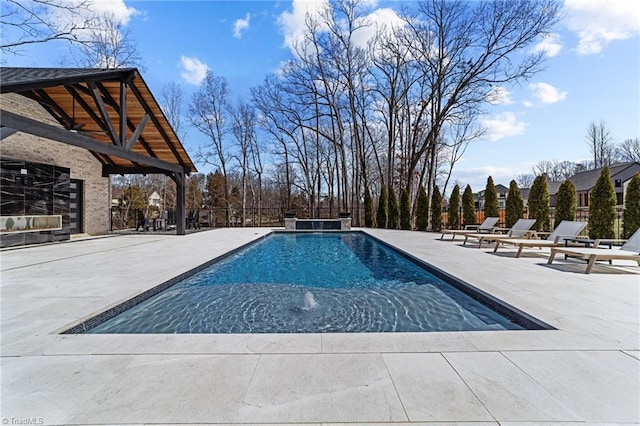 outdoor pool with a patio area and fence