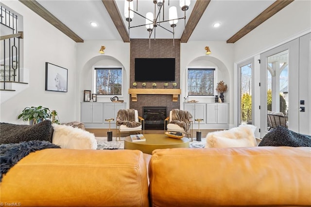 living area with recessed lighting, a large fireplace, stairway, beamed ceiling, and an inviting chandelier