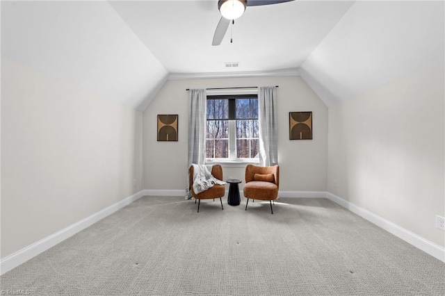 sitting room featuring carpet, baseboards, visible vents, and vaulted ceiling