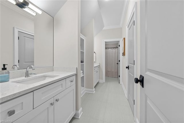 full bathroom with tile patterned flooring, baseboards, and vanity