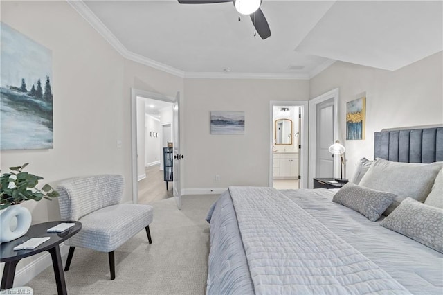 bedroom with light carpet, crown molding, ensuite bath, and baseboards