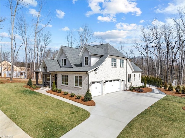 view of front facade with an attached garage, brick siding, concrete driveway, roof with shingles, and a front lawn