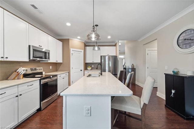 1423 Blooming Mountain Way, Kernersville, NC 27284 - kitchen with a kitchen breakfast bar, visible vents, crown molding, a sink, and stainless steel appliances