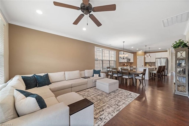1423 Blooming Mountain Way, Kernersville, NC 27284 - living area featuring crown molding, recessed lighting, ceiling fan with notable chandelier, and dark wood-style flooring