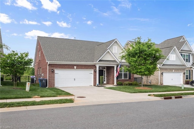 1423 Blooming Mountain Way, Kernersville, NC 27284 - view of front of home with driveway, a front yard, brick siding, an attached garage, and a shingled roof