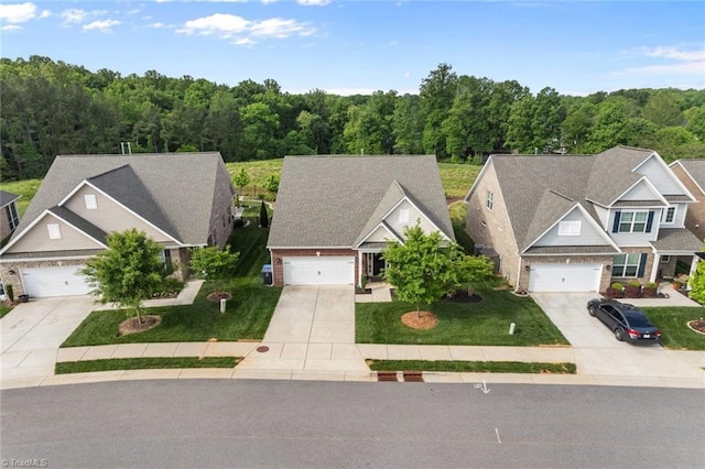 1423 Blooming Mountain Way, Kernersville, NC 27284 - view of front of property featuring a view of trees, driveway, a front lawn, and brick siding