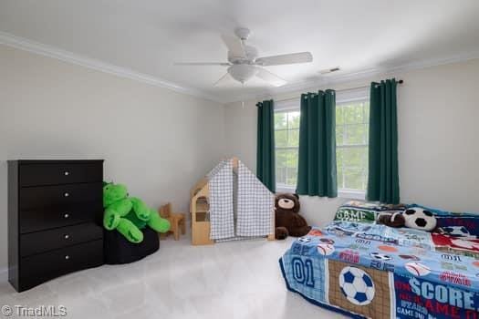 bedroom with ceiling fan and ornamental molding