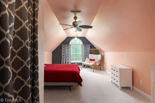 carpeted bedroom with ceiling fan and lofted ceiling