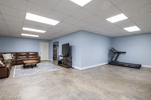 unfurnished living room featuring a paneled ceiling