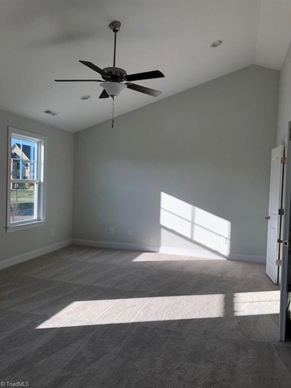 unfurnished room with visible vents, baseboards, a ceiling fan, carpet floors, and vaulted ceiling