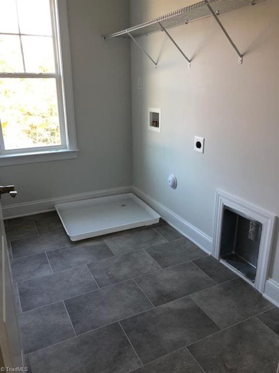 washroom with electric dryer hookup, laundry area, baseboards, and washer hookup