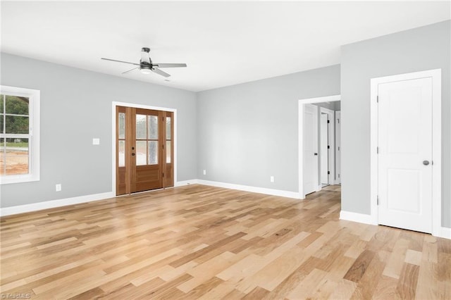 foyer entrance featuring ceiling fan, light wood-type flooring, and baseboards