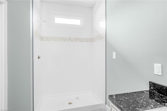 bathroom with a shower stall and vanity