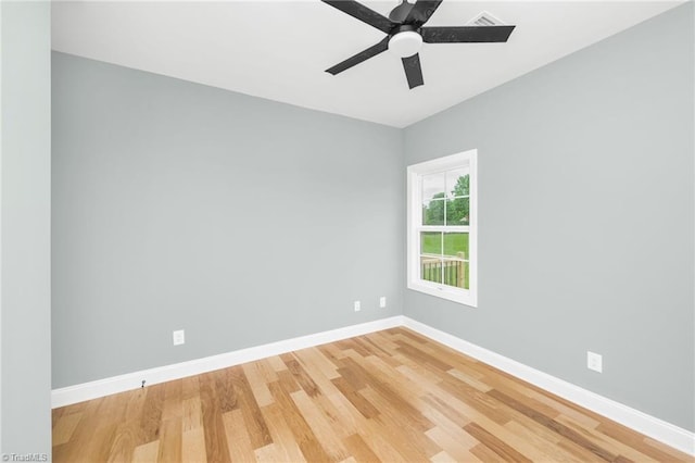 spare room featuring light wood-style floors, baseboards, and a ceiling fan