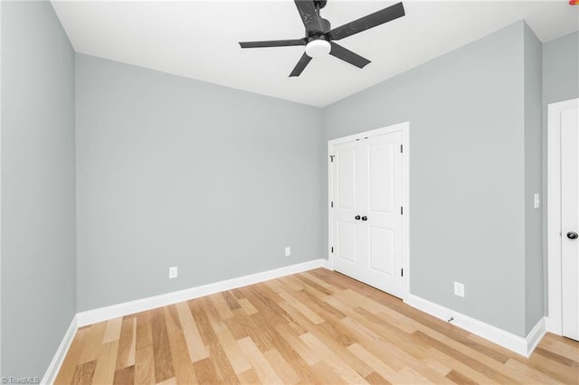 unfurnished bedroom with light wood-style floors, baseboards, and a closet
