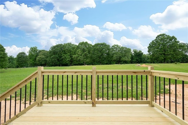 wooden deck featuring a lawn