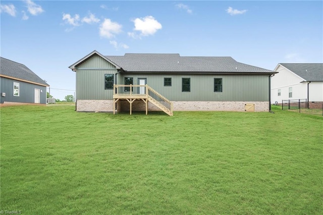 back of house featuring a deck, stairway, and a yard
