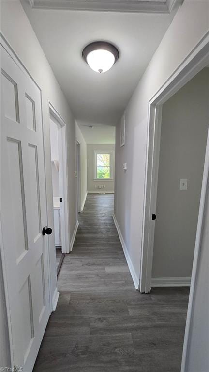 hall with baseboards and dark wood finished floors
