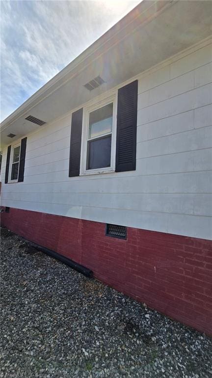 view of home's exterior with crawl space