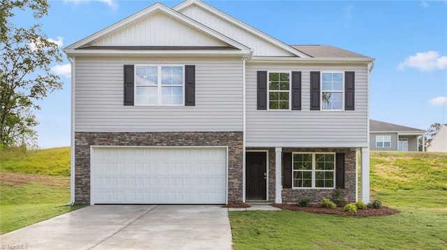 162 W Farm Loop, Stokesdale, NC 27537 - view of front of home with a front yard, an attached garage, stone siding, and concrete driveway