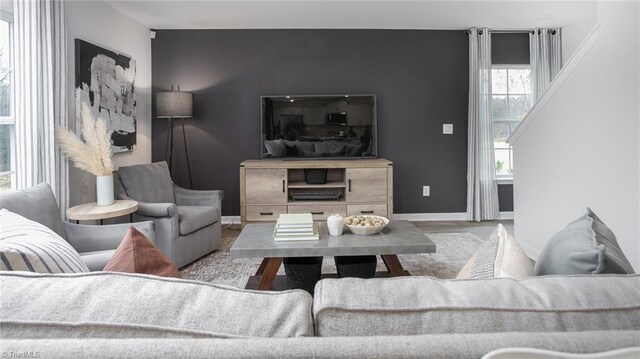 162 W Farm Loop, Stokesdale, NC 27537 - living room featuring wood finished floors, an accent wall, and baseboards