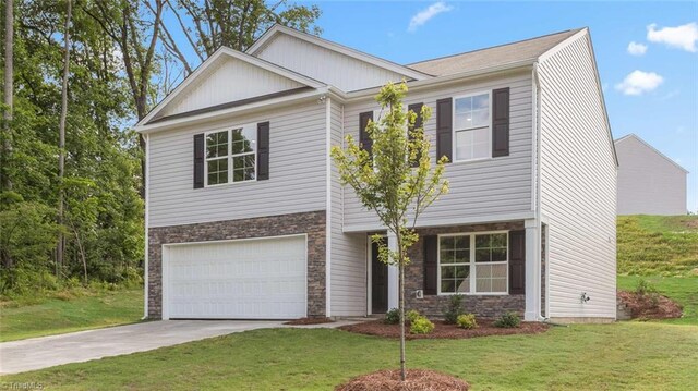 162 W Farm Loop, Stokesdale, NC 27537 - view of front facade with concrete driveway, a garage, stone siding, and a front yard