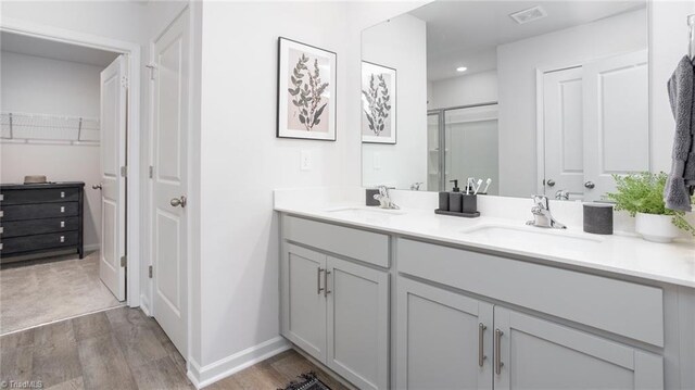 162 W Farm Loop, Stokesdale, NC 27537 - full bath featuring a sink, a shower stall, double vanity, and wood finished floors