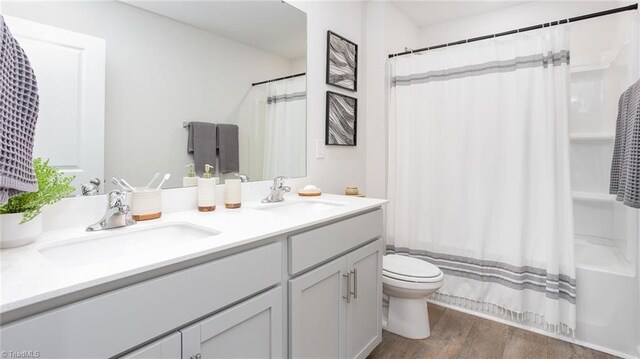 162 W Farm Loop, Stokesdale, NC 27537 - bathroom featuring a sink, toilet, double vanity, and wood finished floors