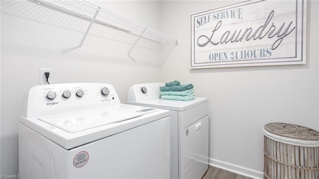162 W Farm Loop, Stokesdale, NC 27537 - washroom featuring baseboards, wood finished floors, washing machine and dryer, and laundry area