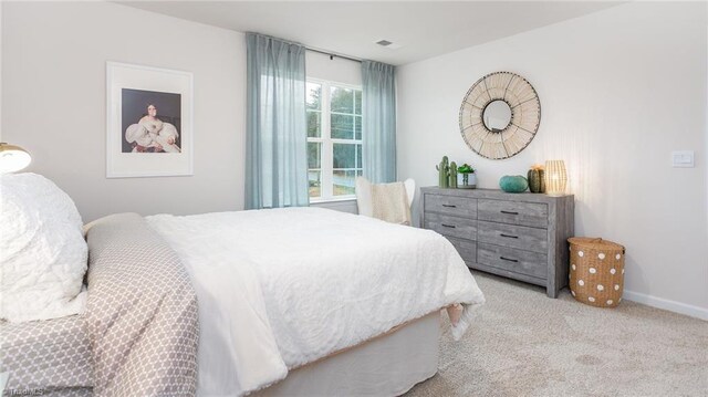 162 W Farm Loop, Stokesdale, NC 27537 - carpeted bedroom featuring baseboards and visible vents