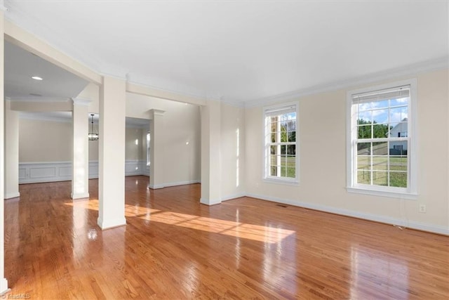 unfurnished room with light hardwood / wood-style floors and ornamental molding