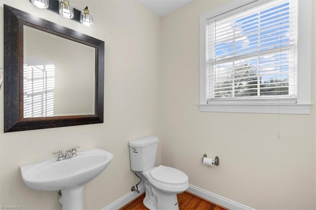 bathroom with sink, toilet, and hardwood / wood-style flooring