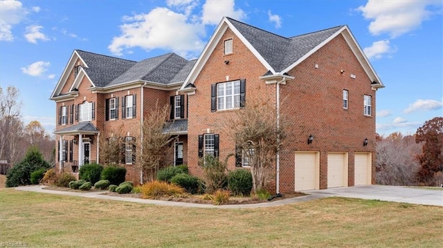 view of front of home with a front yard and a garage