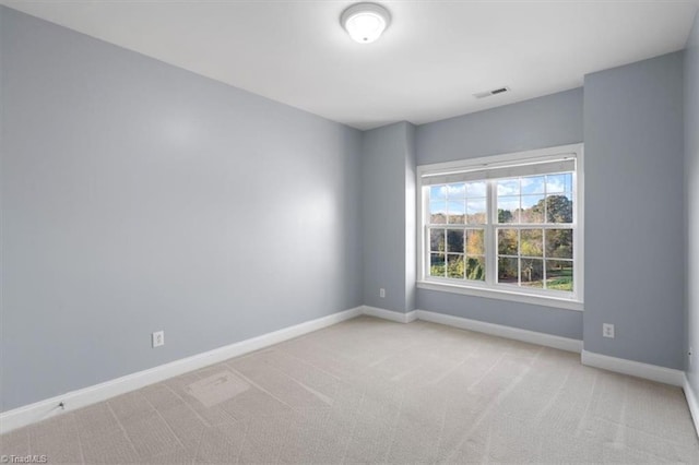 spare room with light colored carpet