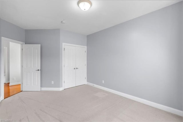 unfurnished bedroom with a closet and carpet floors