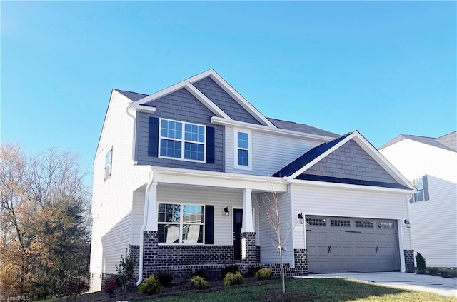 craftsman-style home with a garage, a porch, and a front yard