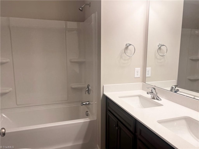 full bathroom with double vanity,  shower combination, and a sink