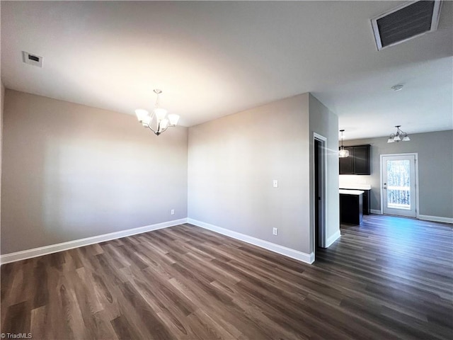 spare room featuring visible vents, baseboards, and a chandelier