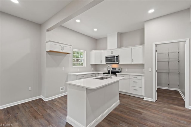 2500 Lomond St, Winston-Salem, NC 27127 - kitchen featuring appliances with stainless steel finishes, dark wood-style flooring, white cabinetry, a kitchen island with sink, and recessed lighting