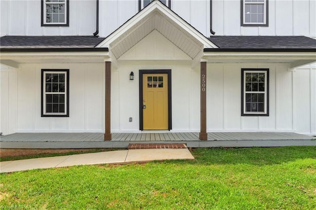2500 Lomond St, Winston-Salem, NC 27127 - doorway to property featuring covered porch, a lawn, and roof with shingles