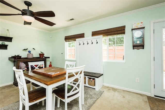 304 Walnut Crossing Dr, Whitsett, NC 27377 - dining space featuring crown molding, baseboards, ceiling fan, and carpet