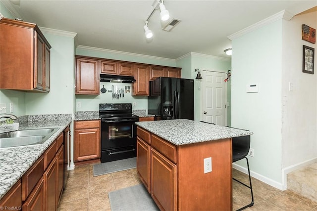 304 Walnut Crossing Dr, Whitsett, NC 27377 - kitchen with black appliances, a sink, a kitchen bar, a kitchen island, and under cabinet range hood