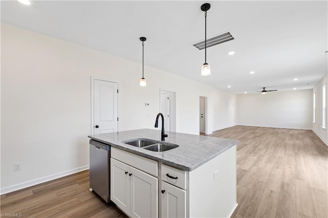 kitchen featuring visible vents, ceiling fan, a sink, stainless steel dishwasher, and light wood-type flooring