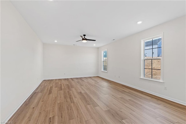 unfurnished room with recessed lighting, a ceiling fan, light wood-type flooring, and baseboards