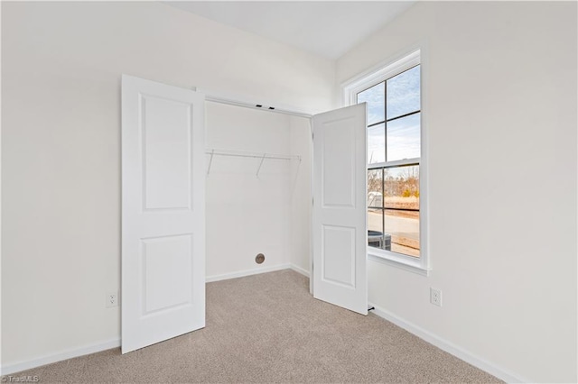 interior space with baseboards and carpet