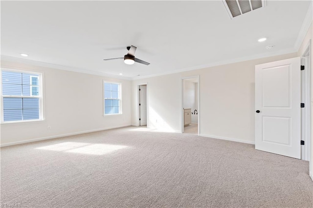 unfurnished room featuring visible vents, a ceiling fan, crown molding, baseboards, and light colored carpet