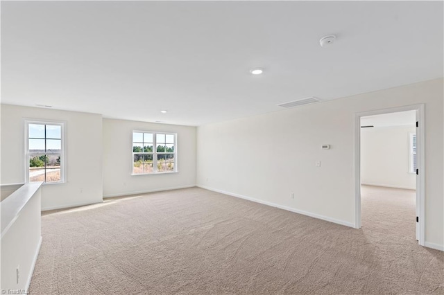 carpeted spare room with recessed lighting, visible vents, and baseboards